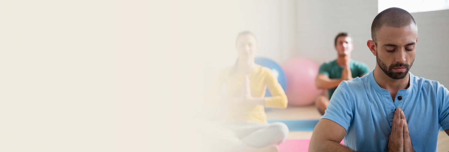 Group of people meditating indoors for wellness