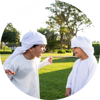 Two kids looking at each other laughing and playing, represents clear communication
