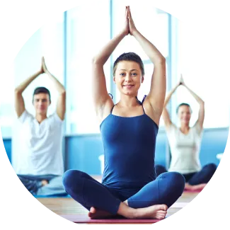 A group of people practicing advanced yoga poses during Sri Sri Yoga Level 2