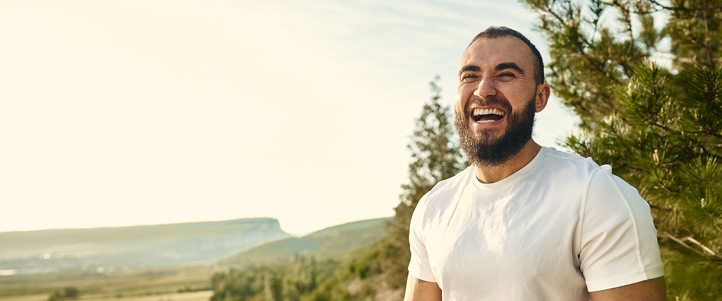 A man in white t shirt with bright laughter