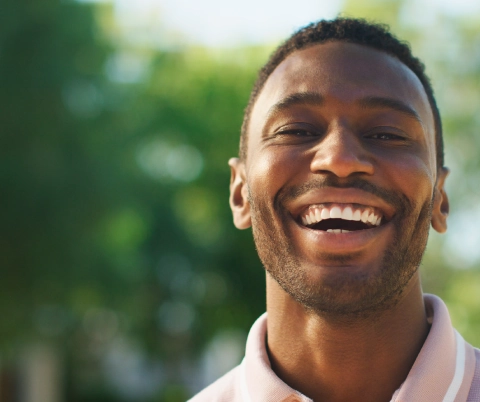 A man with bright laughter under open sky
