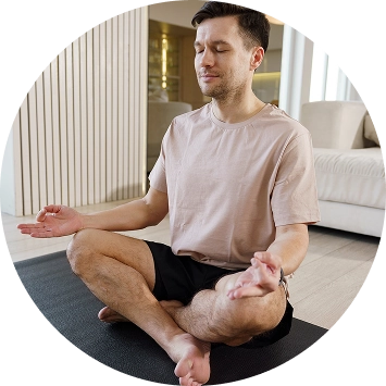 A woman practicing yoga during art of living's sahaj samadhi course