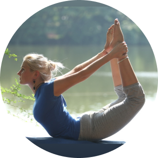 A woman performaing yoga asanas as part of Sri Sri Yoga advanced level for a healthier lifestyle