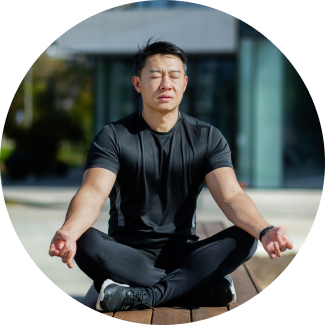 Fit man in black sports wear, meditating in outdoors