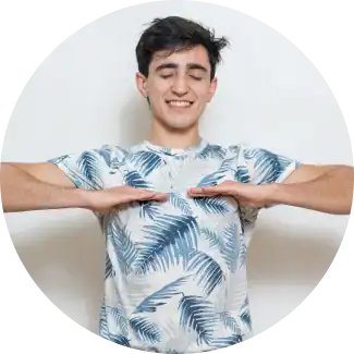 Ein lächelnder Mann mit nach unten gerichteten Handflächen bei einer Atemübung