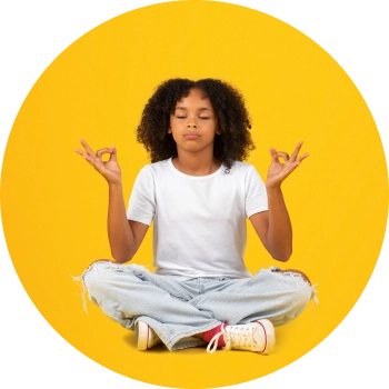 A boy sitting against yellow background and meditating with his hands in Akasha mudra