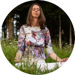 A smiling male with both his palms facing downwards performing breathing exercise