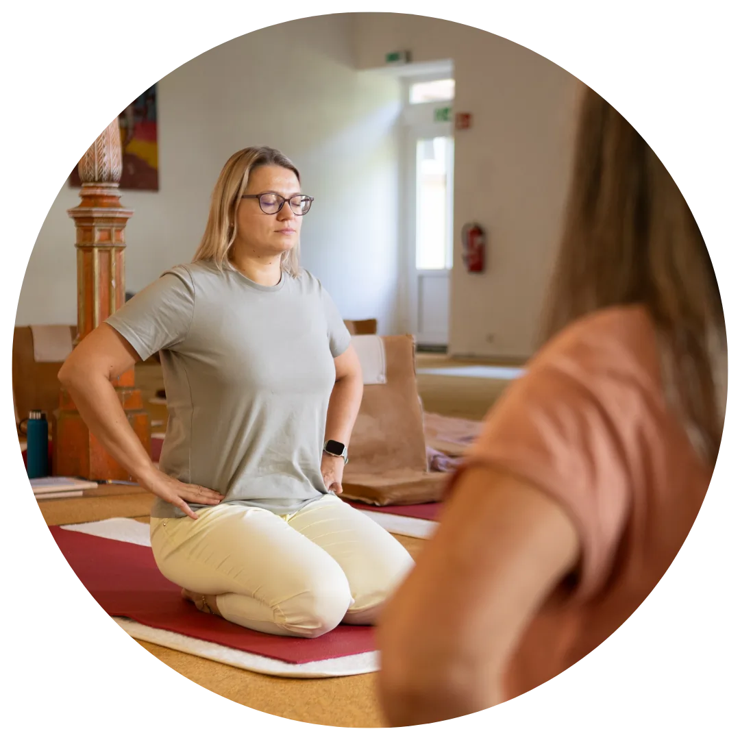 A smiling male with both his palms facing downwards performing breathing exercise