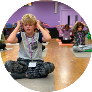 Young boy in blue shirt playing chess, focused on developing strategic thinking skills.