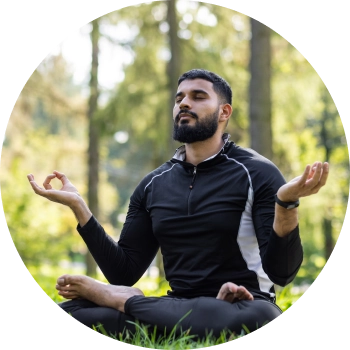 Fit man in black sports wear, meditating in outdoors