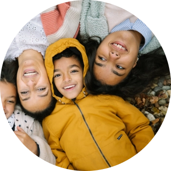 Diverse group of kids lying next to each other and smiling