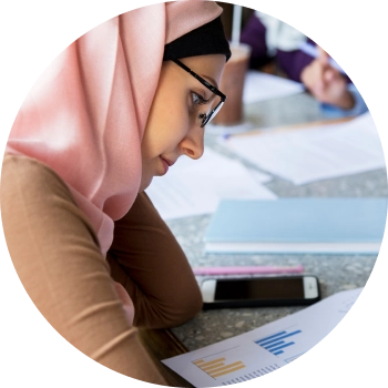 Student writing in a notebook, creating a focused environment for learning and self-confidence.