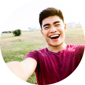 A young boy smiling widely in a selfie cam 