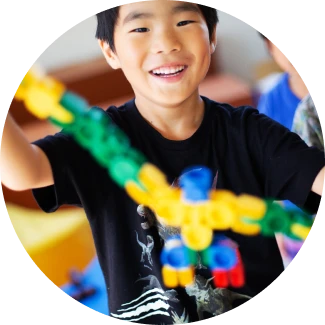 A boy with complex lego structure showing learning abilities 