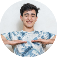 A smiling male with both his palms facing downwards performing breathing exercise