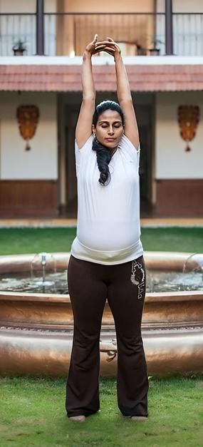 Yoga Tadasana - a lady standing straight with raised hands in tadasana yoga pose