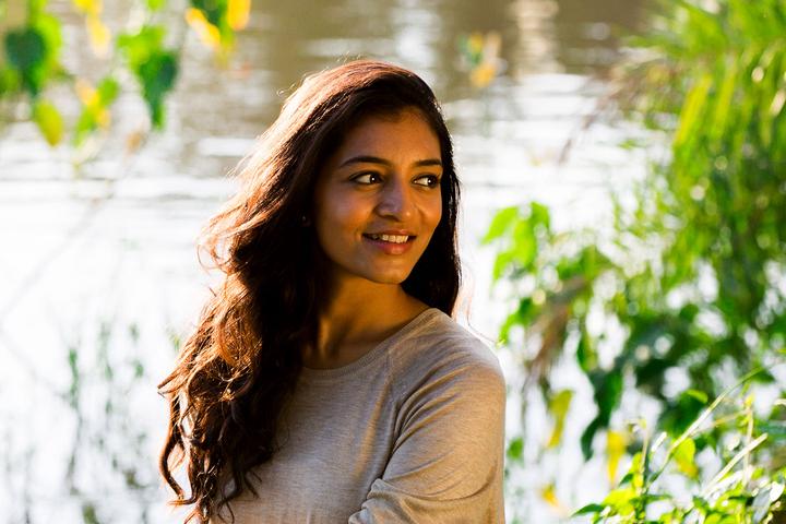 meditation yoga - smiling young woman near a lake