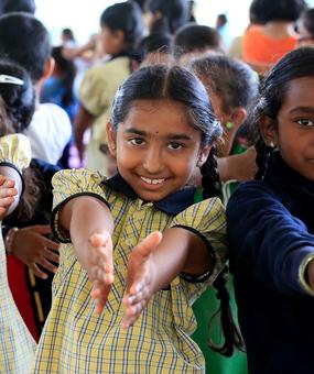 school students extending hands