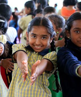 school students extending hands