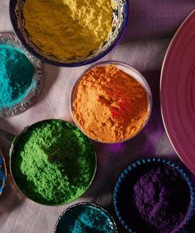 Different colours kept in bowls for playing Holi