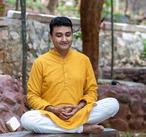 a man meditating in Radha Kunj