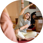A smiling male with both his palms facing downwards performing breathing exercise
