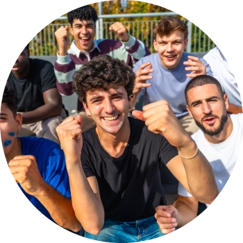 Group of teens forming a circle and smiling by facing downwards