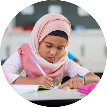 A kid with pink hijab taking notes with keen focus and attention