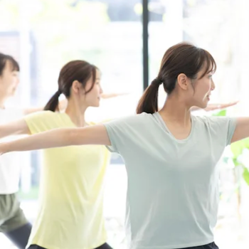 A man performing yoga asana in a bright spacious room