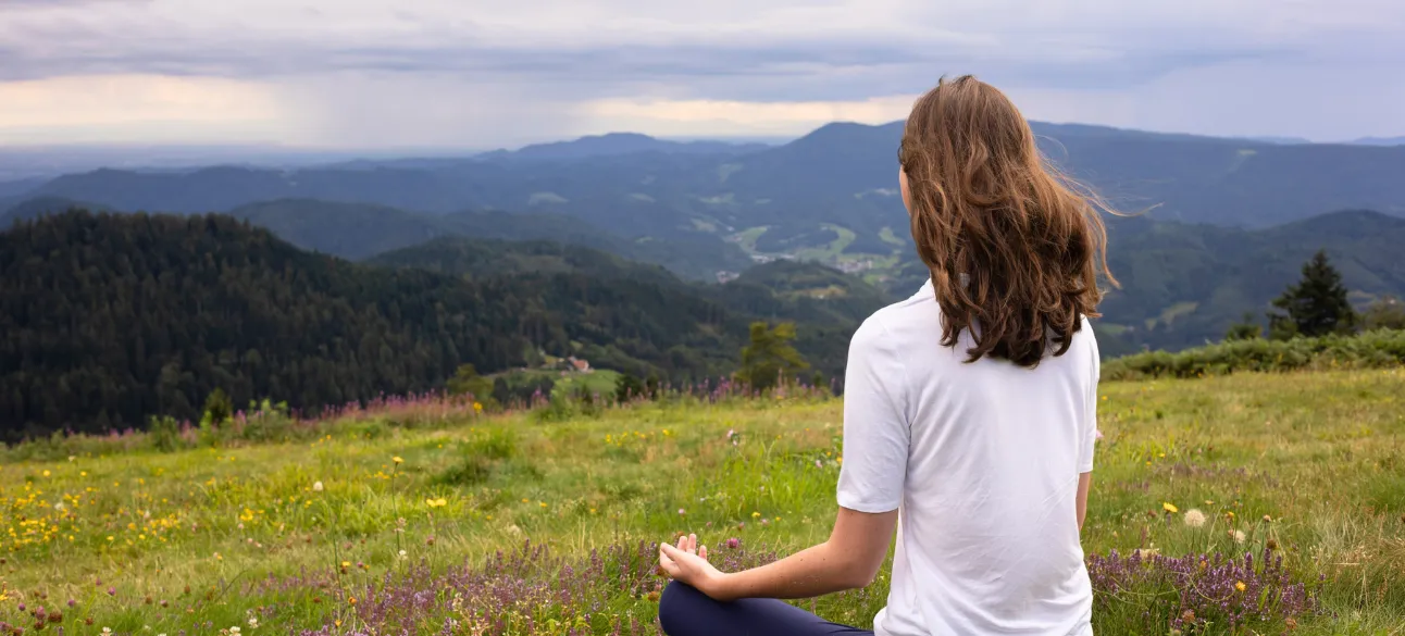 Group of people meditating indoors for wellness