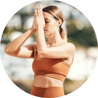 A woman performing yoga asana with crossed legs and twisted hands
