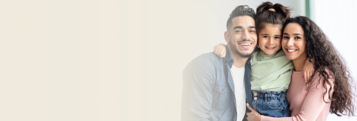 A mother in black burqa standing with her two kids, all three smiling joyfully