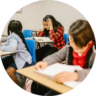 Student writing in a notebook, creating a focused environment for learning and self-confidence.