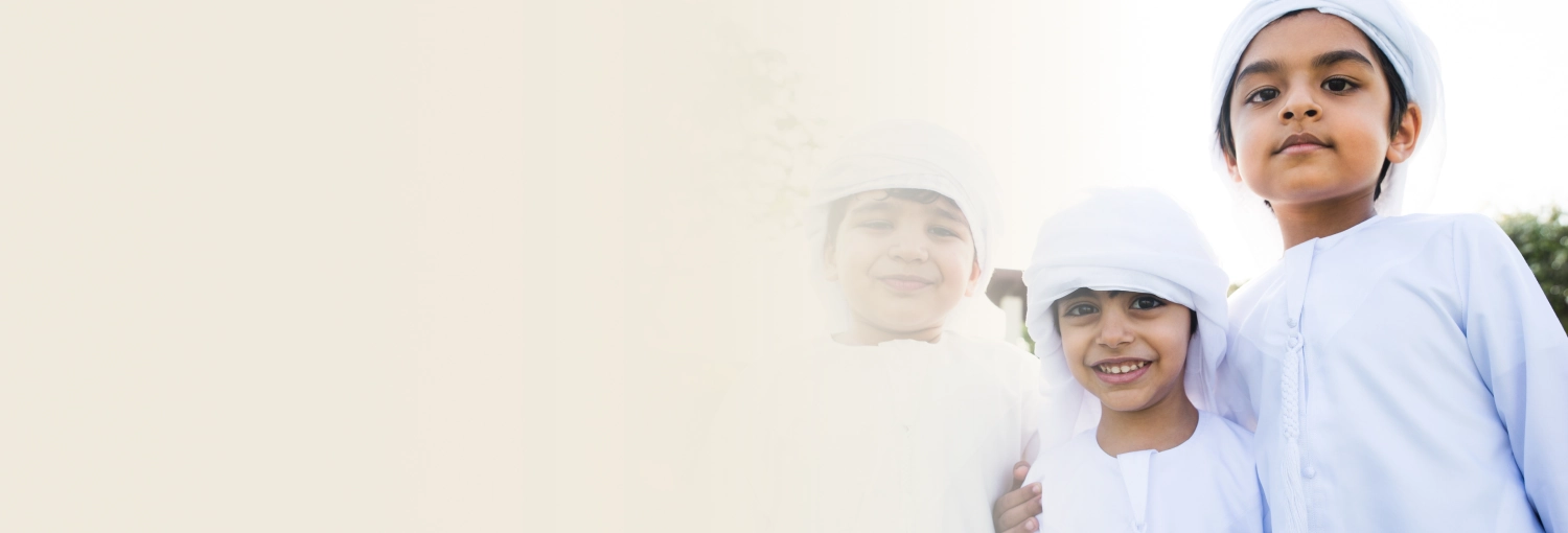 Kids in white thobe smiling with joy