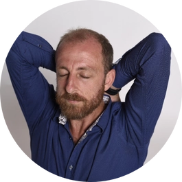 A smiling male with both his palms facing downwards performing breathing exercise