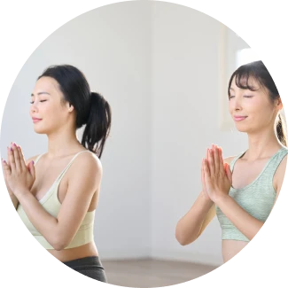 A group of people practicing advanced yoga poses during Sri Sri Yoga Level 2