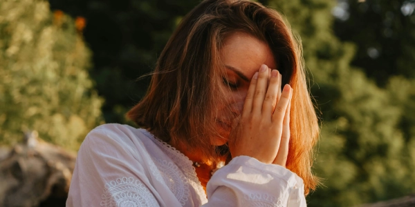 Person receiving healing energy during Art of Living Blessings program, showing moment of deep spiritual connection