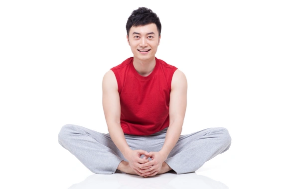 Asian men practicing Butterfly Yoga pose