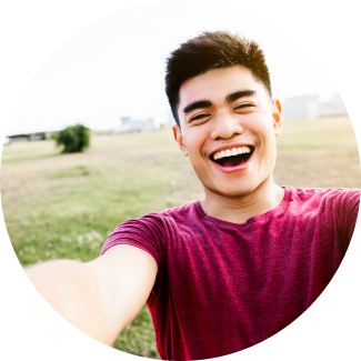 A young boy smiling widely in a selfie cam 
