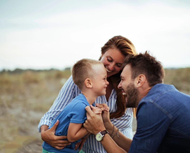 Happy family enjoying outdoor time, symbolizing positive parent-child bonding