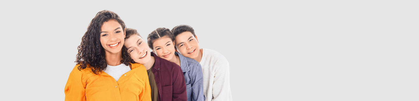 Group of smiling teenagers against an white background, capturing the cheerful vibe of a teen workshop.