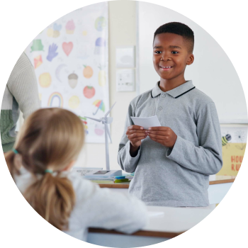 A boy giving his speech in the classroom with confidence