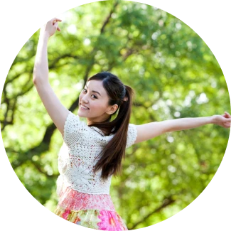 A teenage girl jumping with a smile representing good health
