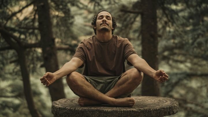 Man practicing slow rhythmic breathing outdoors.