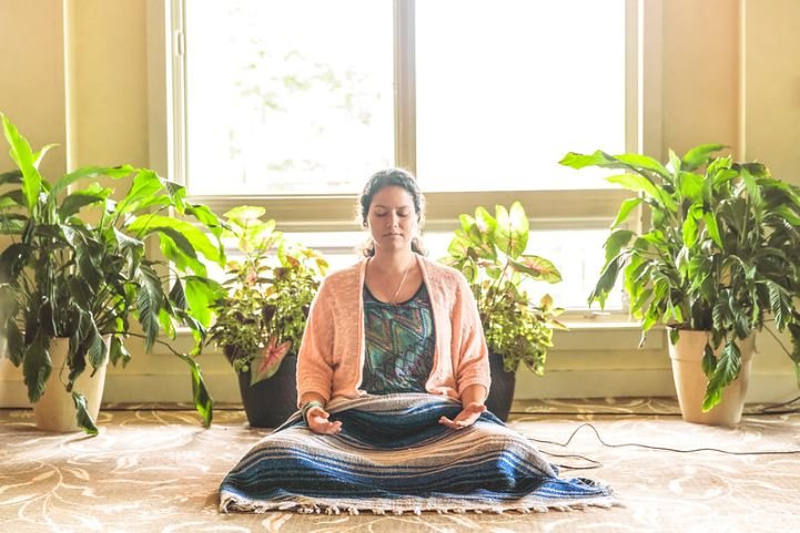 Woman practicing SKY Breath Meditation for improved productivity.