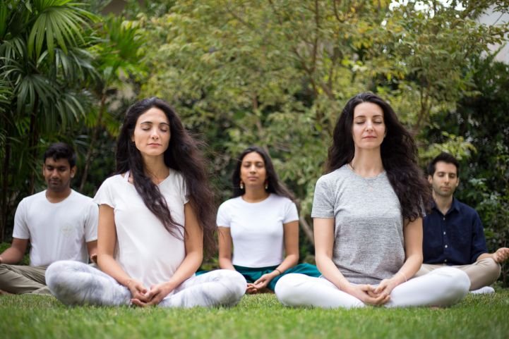 A group practicing SKY Breath Meditation outside.