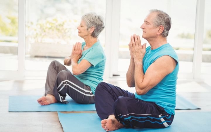 Older couple practicing yoga for heart health