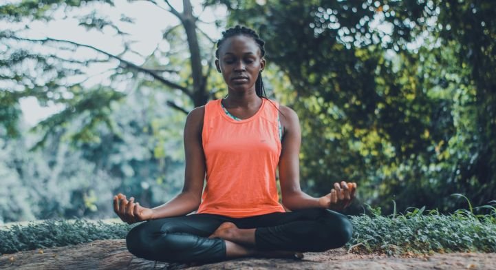 woman practicing meditation outside