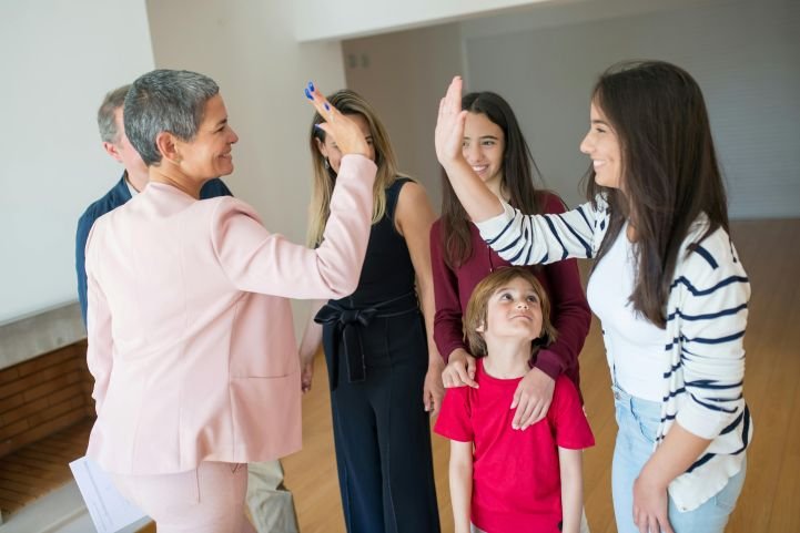 two-women-high-fiving-at-parent-support-group