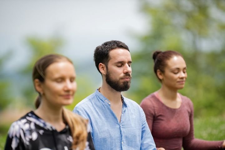 small-group-practicing-SKY-Breath-Meditation-outside